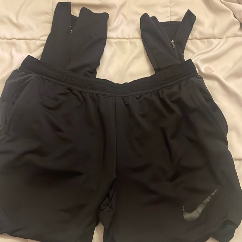 Very nice black Nike jogging pants tappered legs with zippers
